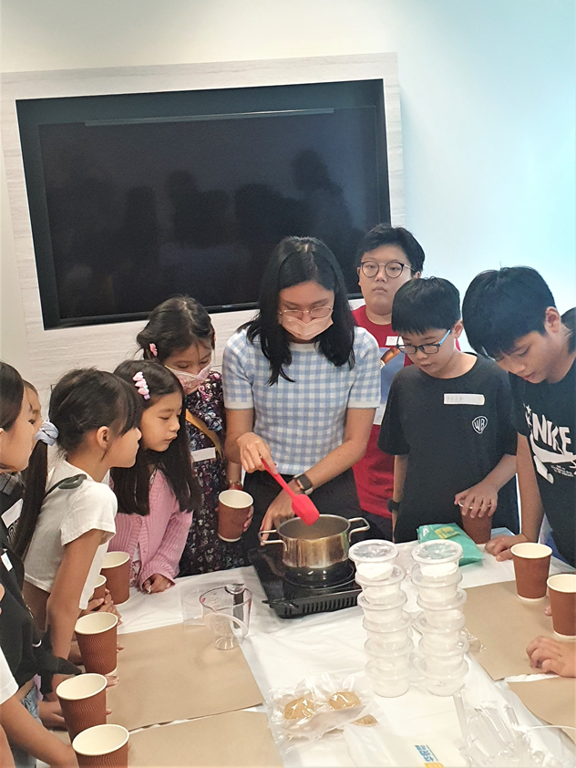 Teacher showing the process of making boba