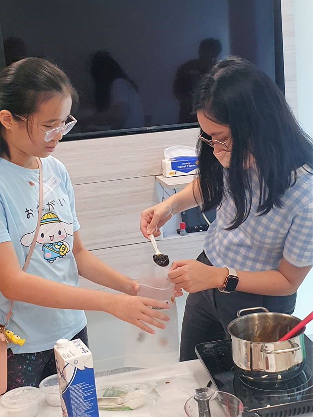 Teacher giving ready-made boba to student